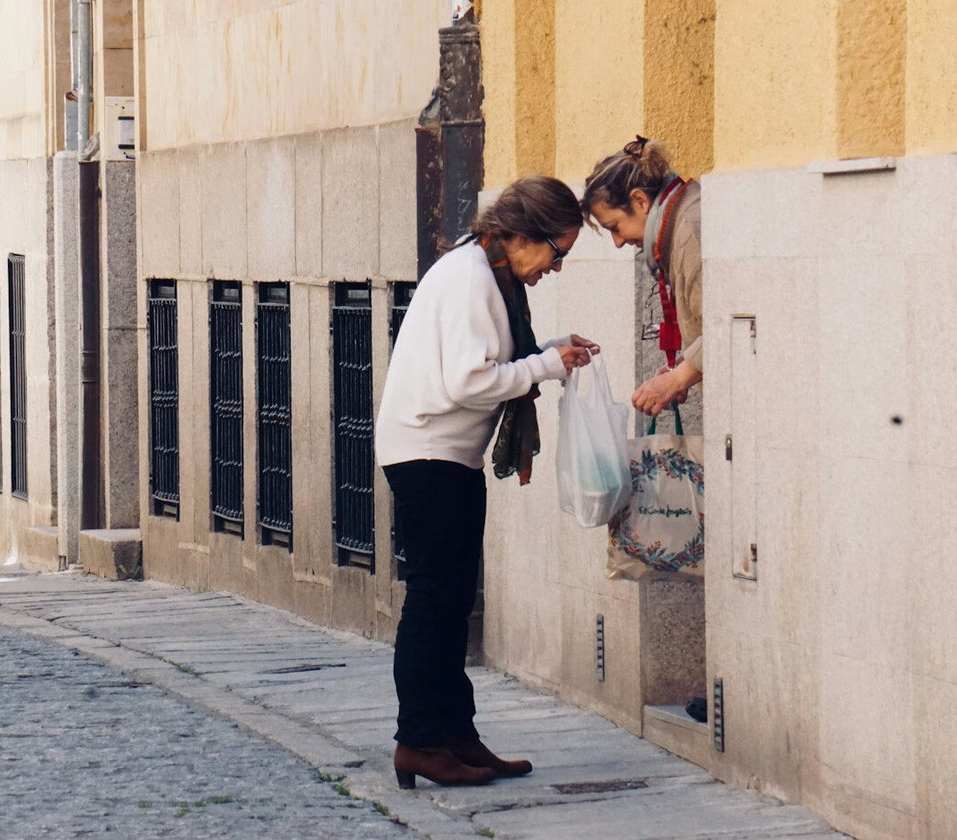 senior woman helping neighbor